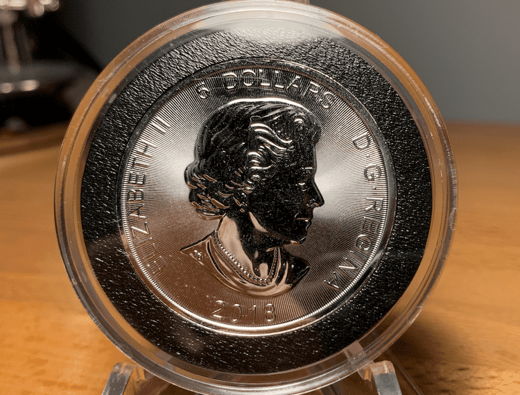 The obverse of a 2018 encapsulated predator series wolf silver maple leaf coin.