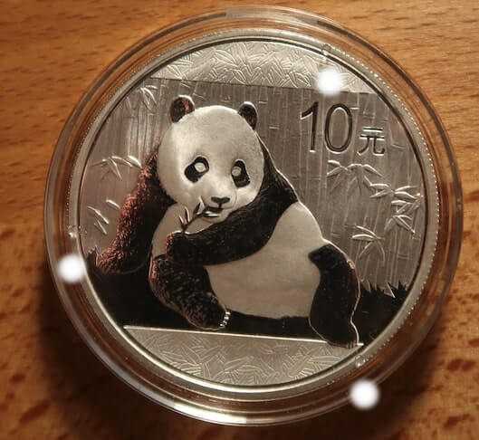 An image of an authentic 2015 Chinese Silver Panda in a capsule with 3 nibs clearly indicated.