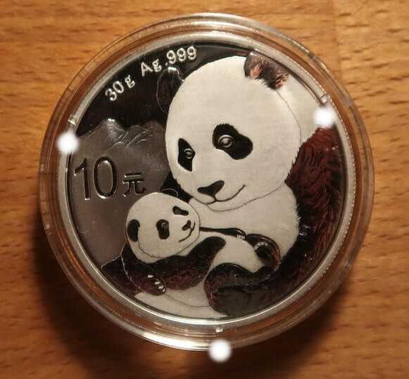 An image of an authentic 2018 Chinese Silver Panda in a capsule with three nibs clearly indicated.