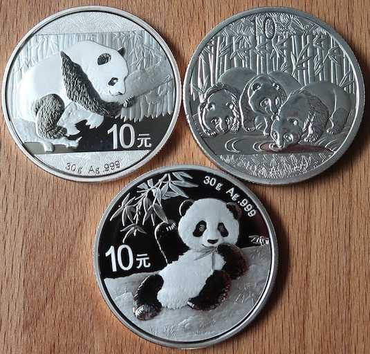 Comparing the reverse between two authentic Chinese Silver Pandas and one counterfeit Chinese Silver Panda.